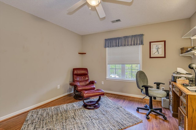 office with ceiling fan, wood-type flooring, and a textured ceiling