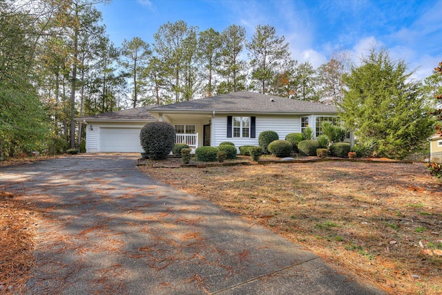 ranch-style home featuring a porch and a garage