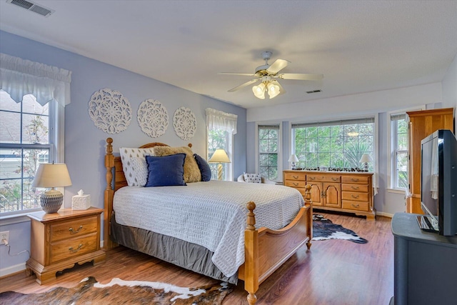 bedroom with ceiling fan and wood-type flooring