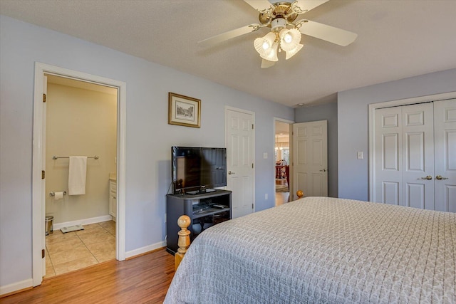 bedroom with wood-type flooring, a textured ceiling, ensuite bath, and ceiling fan