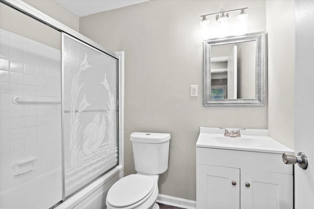 full bathroom with vanity, combined bath / shower with glass door, and toilet