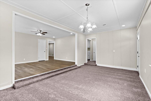 unfurnished room featuring carpet flooring and ceiling fan with notable chandelier