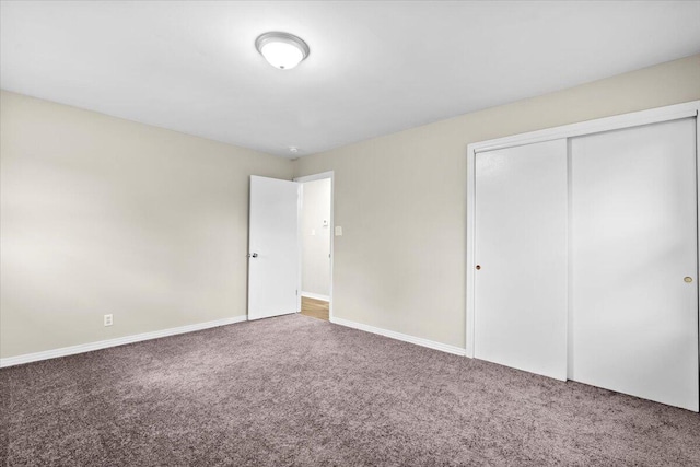 unfurnished bedroom with carpet flooring and a closet