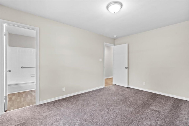 unfurnished bedroom with carpet floors and connected bathroom