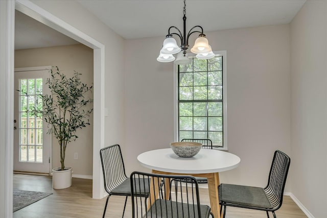 3204 Bel Ridge Rd, Augusta, GA 30909 - dining space featuring light wood-style flooring, baseboards, and a notable chandelier