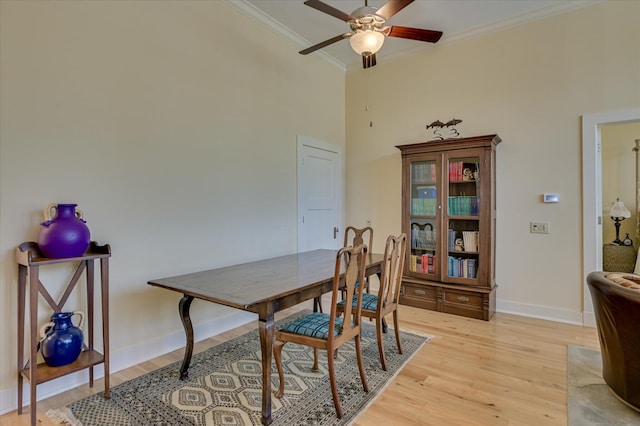2349 Williams St, Augusta, GA 30904 - dining room featuring ornamental molding, ceiling fan, light wood-style flooring, baseboards, and a towering ceiling