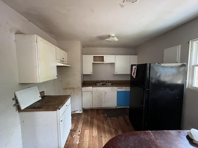 kitchen featuring dishwasher, black fridge, sink, dark hardwood / wood-style floors, and white cabinetry