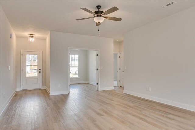 unfurnished living room featuring ceiling fan and light hardwood / wood-style floors