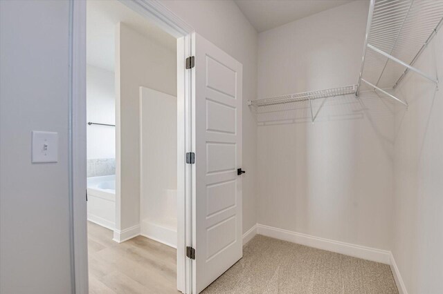 spare room with ceiling fan, french doors, and light hardwood / wood-style floors