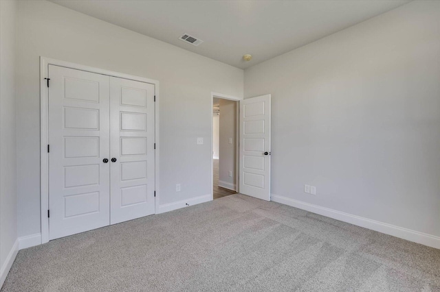 unfurnished bedroom with carpet flooring and a closet