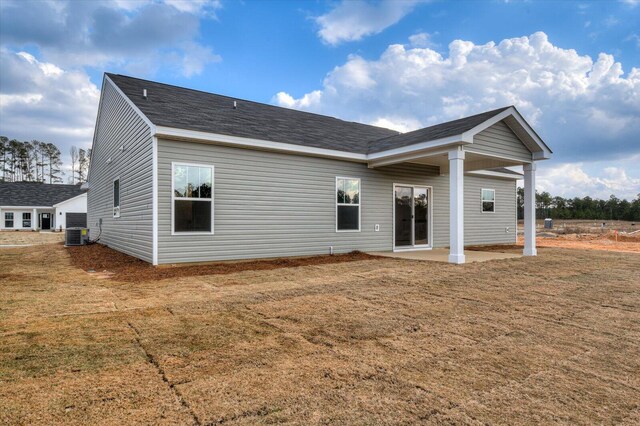 back of property featuring a lawn and cooling unit