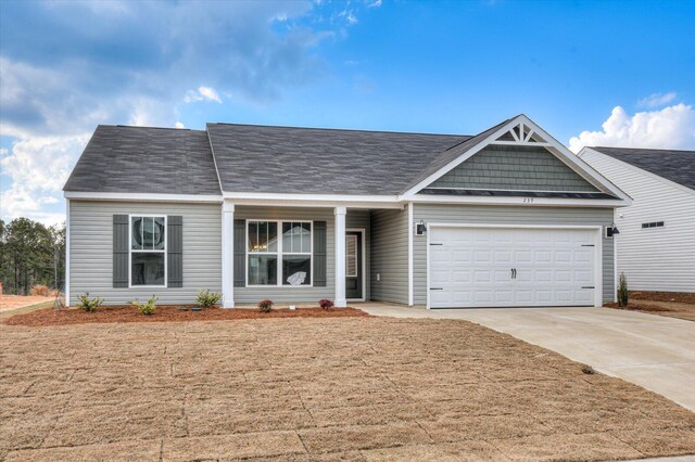 view of front of home featuring a front lawn and a garage