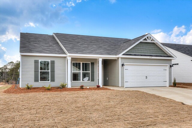 single story home featuring a garage and a front yard