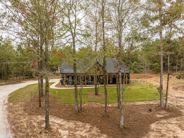 1008 Folly Run Dr, Lincolnton, GA 30817 - view of front facade with a front lawn, driveway, and a forest view