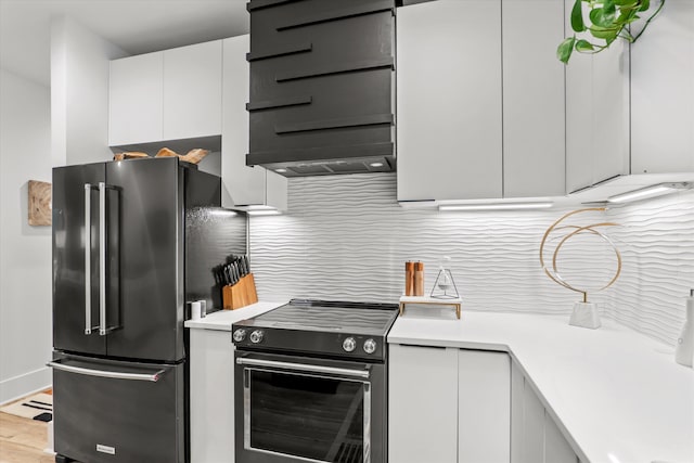 1008 Folly Run Dr, Lincolnton, GA 30817 - kitchen with stainless steel electric range oven, high end fridge, light countertops, white cabinets, and tasteful backsplash