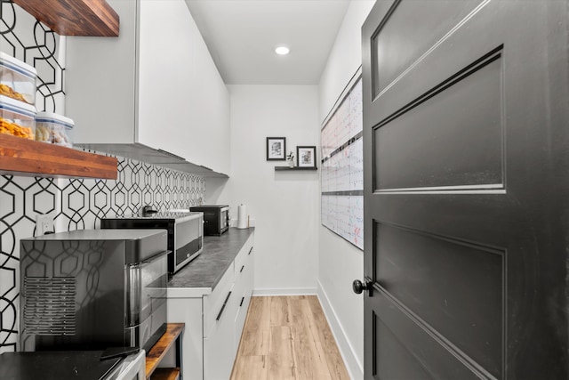 1008 Folly Run Dr, Lincolnton, GA 30817 - kitchen with open shelves, white cabinets, tasteful backsplash, light wood finished floors, and modern cabinets