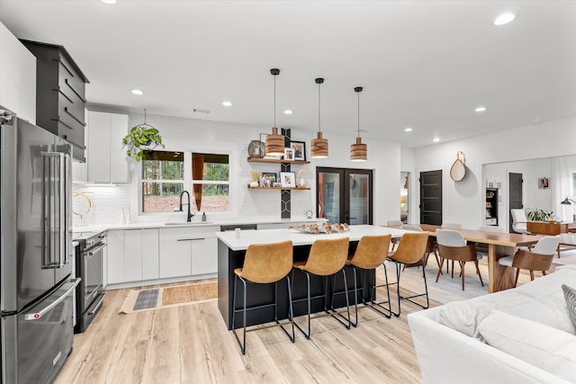 1008 Folly Run Dr, Lincolnton, GA 30817 - kitchen featuring appliances with stainless steel finishes, light countertops, recessed lighting, a kitchen island, and backsplash