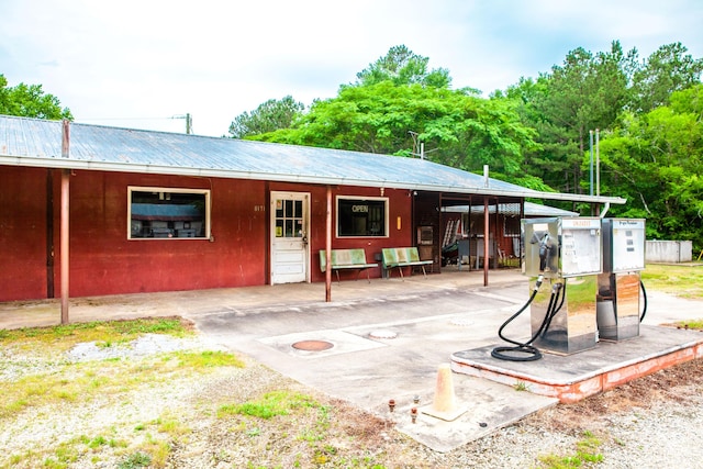 rear view of property featuring an outbuilding