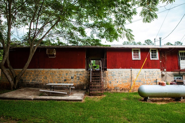 rear view of house with a lawn and a patio