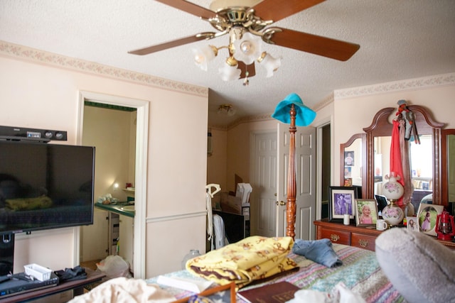 bedroom with ceiling fan and a textured ceiling