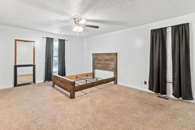 4065 S Goshen Lake Dr, Augusta, GA 30906 - unfurnished bedroom featuring a textured ceiling, a ceiling fan, visible vents, carpet flooring, and baseboards