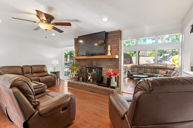 4065 S Goshen Lake Dr, Augusta, GA 30906 - living area featuring a healthy amount of sunlight, wood finished floors, a fireplace, and a ceiling fan