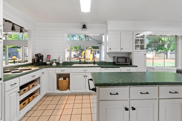 4065 S Goshen Lake Dr, Augusta, GA 30906 - kitchen with white appliances, a wealth of natural light, light tile patterned flooring, a sink, and dark countertops