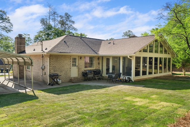 4065 S Goshen Lake Dr, Augusta, GA 30906 - back of house with a sunroom, a carport, a lawn, a chimney, and brick siding