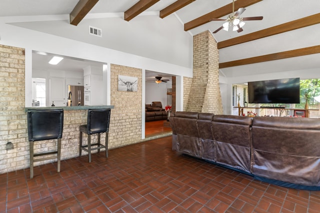 4065 S Goshen Lake Dr, Augusta, GA 30906 - living room with decorative columns, ceiling fan, lofted ceiling with beams, visible vents, and brick floor
