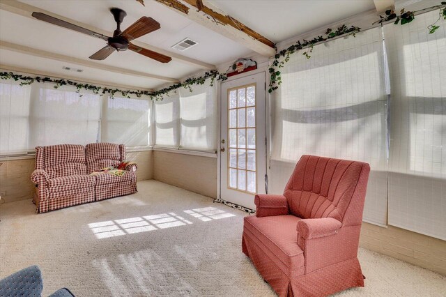 sunroom featuring beamed ceiling and ceiling fan