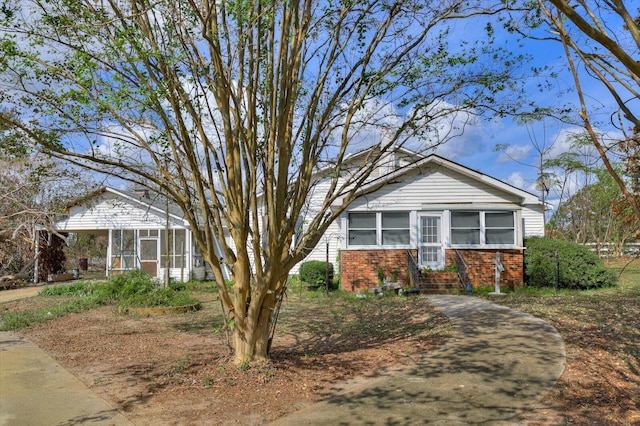 view of front of property featuring a sunroom