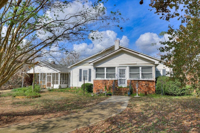 view of front of property featuring a sunroom