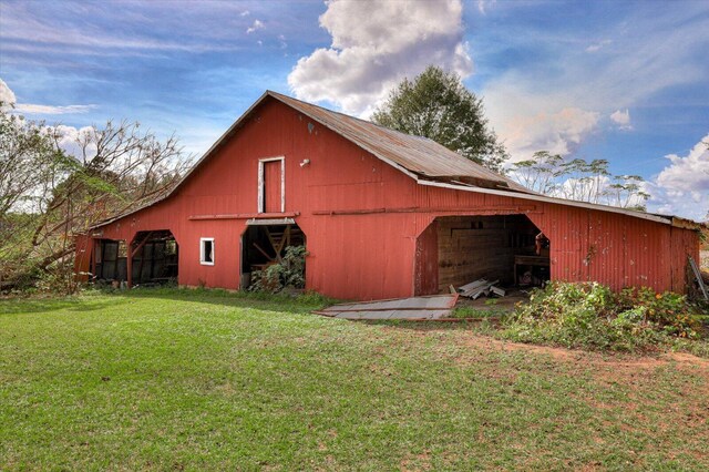 view of outbuilding featuring a lawn