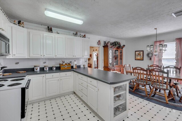 kitchen with white cabinets, white electric range, kitchen peninsula, and a textured ceiling