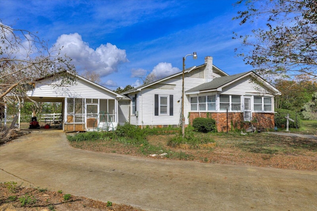 view of front of property featuring a carport and a sunroom