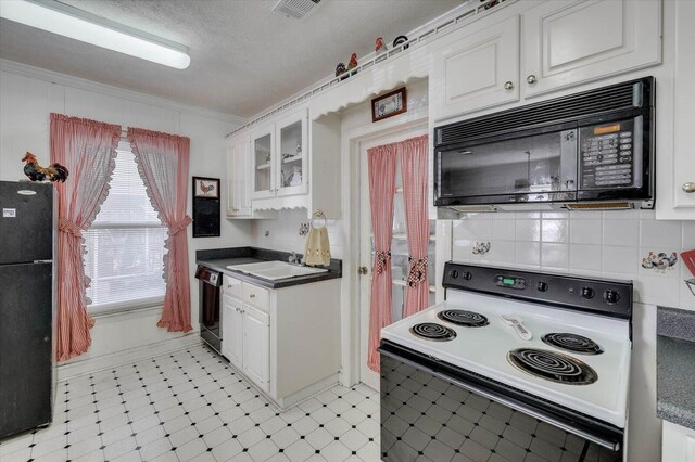 kitchen with a textured ceiling, white cabinetry, and black appliances