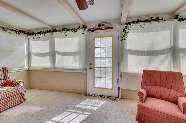 living area with beamed ceiling