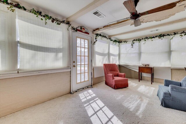 sunroom / solarium with beam ceiling and ceiling fan