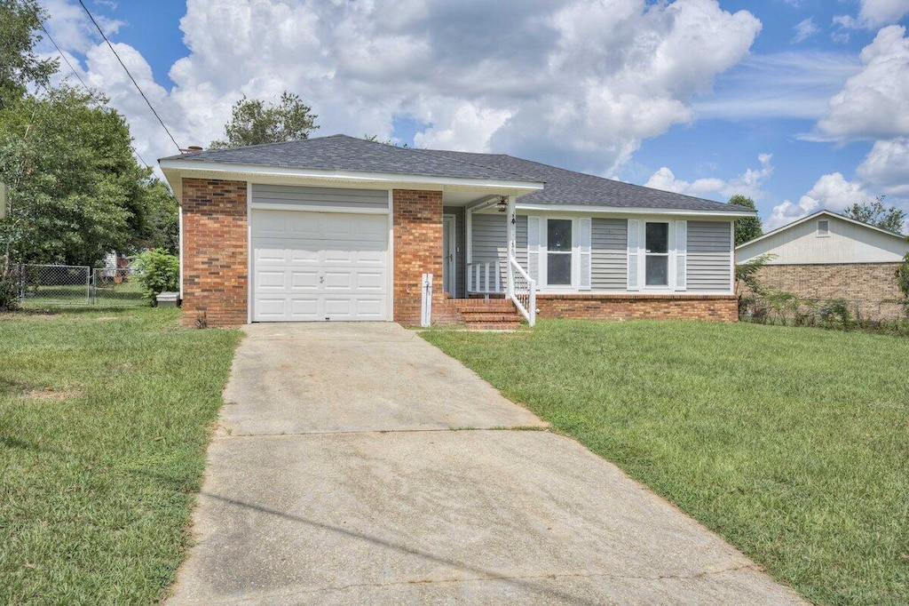 single story home with a front yard and a garage