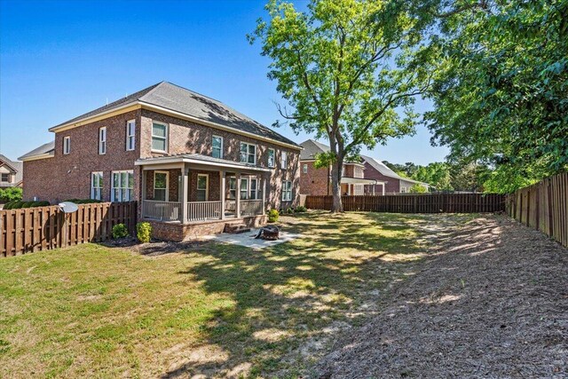 304 Ash Ct, Evans, GA 30809 - rear view of property with a fenced backyard, brick siding, a patio area, an outdoor fire pit, and a yard