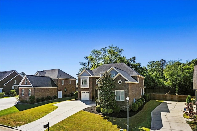 304 Ash Ct, Evans, GA 30809 - view of front of house featuring fence, brick siding, a garage, a front yard, and driveway