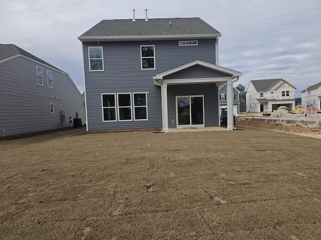 back of house featuring central AC unit