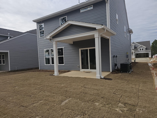 back of house featuring central air condition unit and a patio