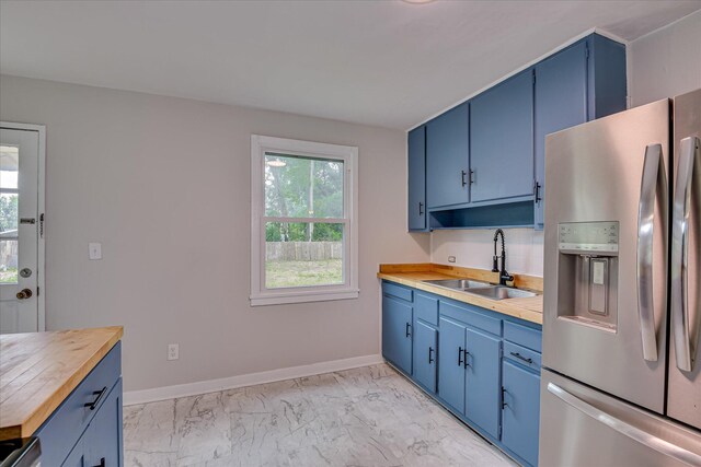 2325 Henry Cir, Augusta, GA 30906 - kitchen featuring stainless steel fridge with ice dispenser, blue cabinets, a sink, butcher block counters, and light marble finish flooring