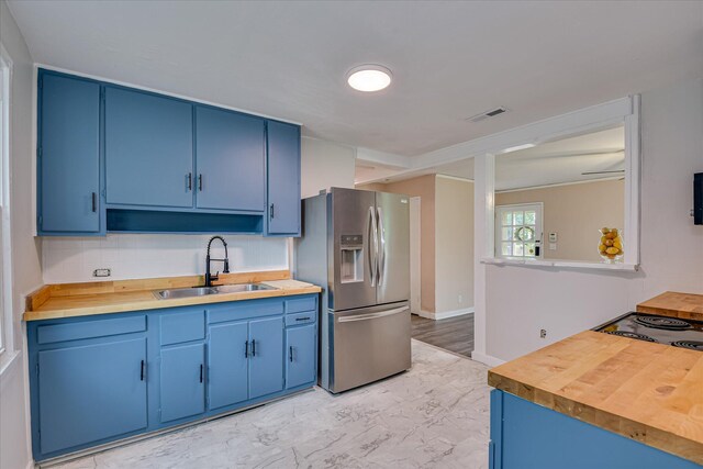 2325 Henry Cir, Augusta, GA 30906 - kitchen featuring stainless steel fridge, blue cabinetry, a sink, and wooden counters