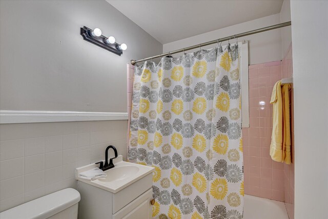 2325 Henry Cir, Augusta, GA 30906 - bathroom with vanity, toilet, tile walls, and shower / bath combo with shower curtain