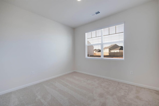 spare room with light carpet