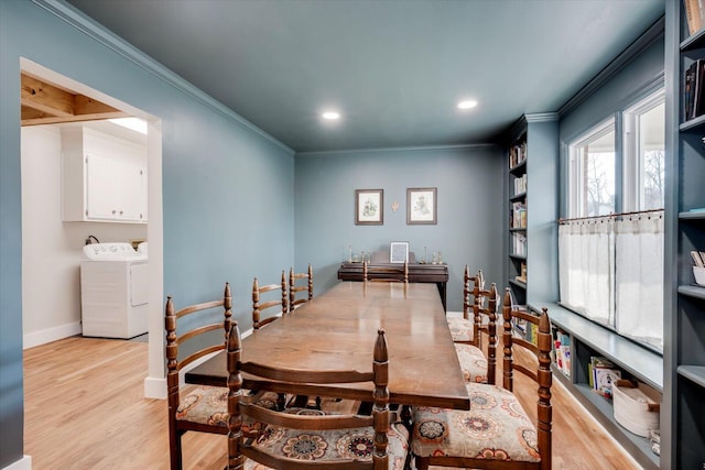 dining room featuring washing machine and dryer, recessed lighting, baseboards, ornamental molding, and light wood finished floors