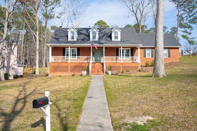 cape cod house with a porch, a front yard, brick siding, and a shingled roof