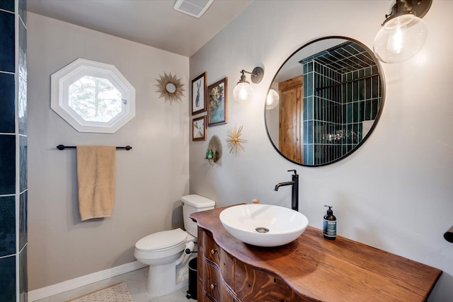 bathroom with baseboards, visible vents, vanity, and toilet